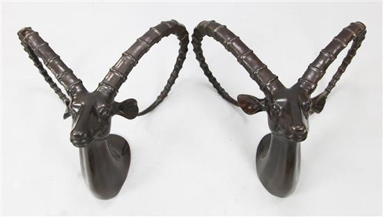 A pair of bronze stands modelled as antelope heads(-)